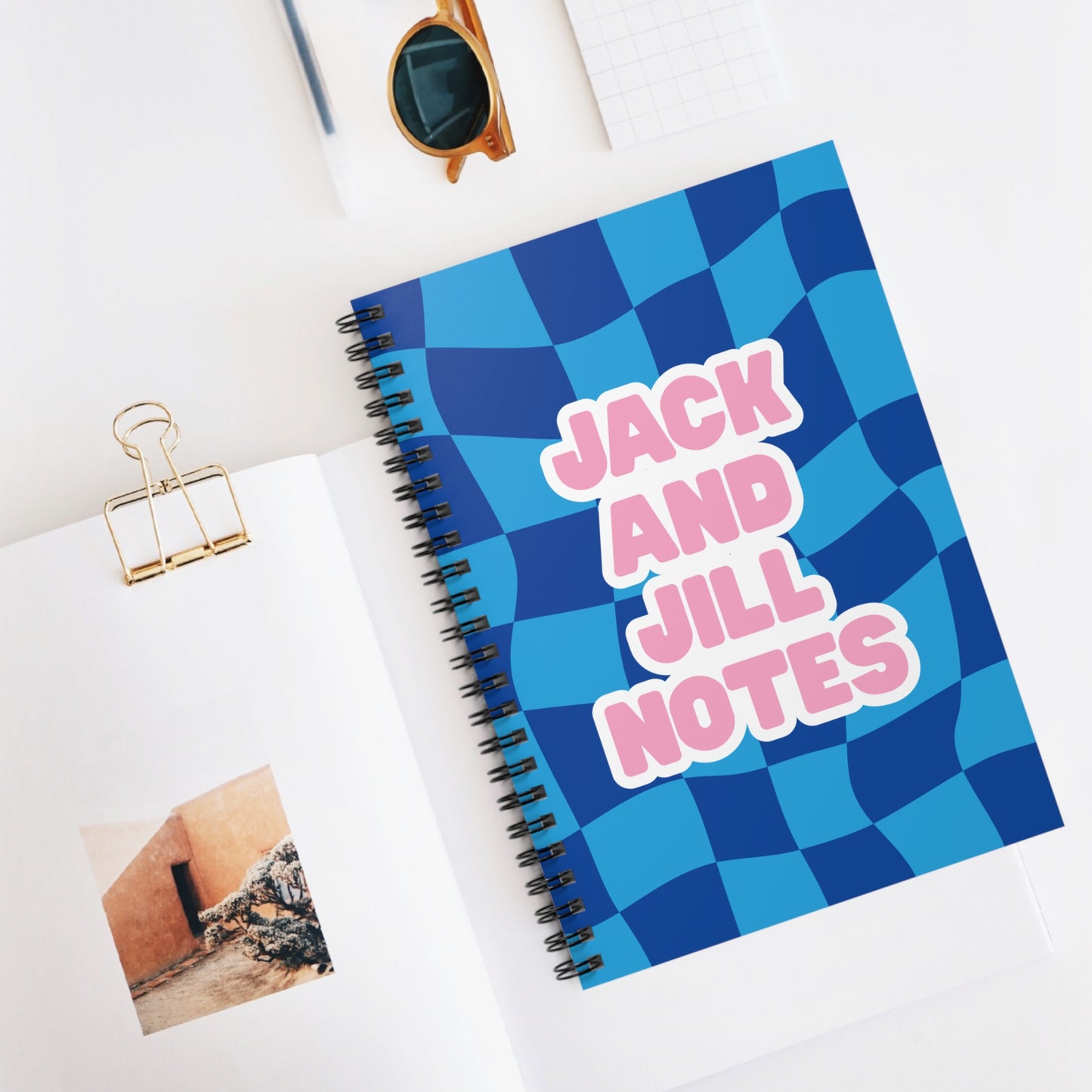 jack and jill of america notebook with blue checkered cover and 'Jack and Jill Notes' text on a white surface.