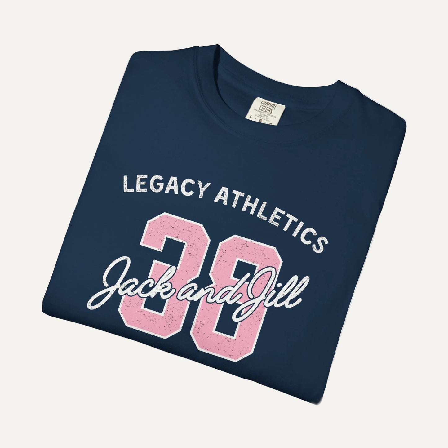 Folded navy blue t-shirt with 'Legacy Athletics Jack and Jill' text on a white background for jack and jill moms and jack and jill dads
