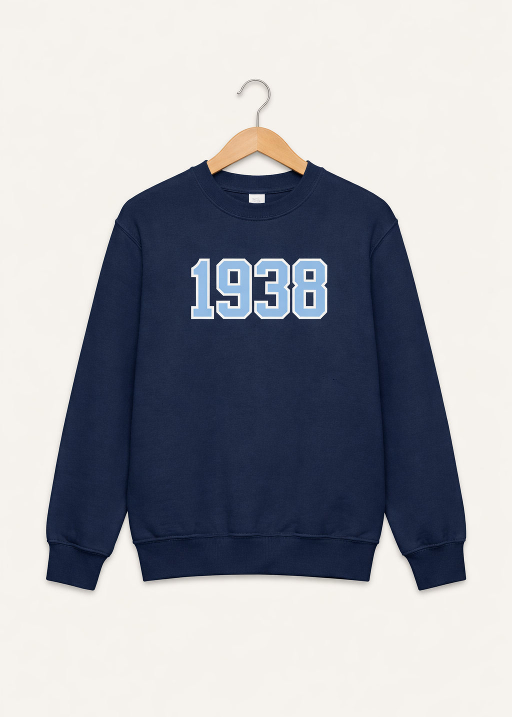 Navy blue sweatshirt with '1938' printed on it, hanging on a wooden hanger against a white background.