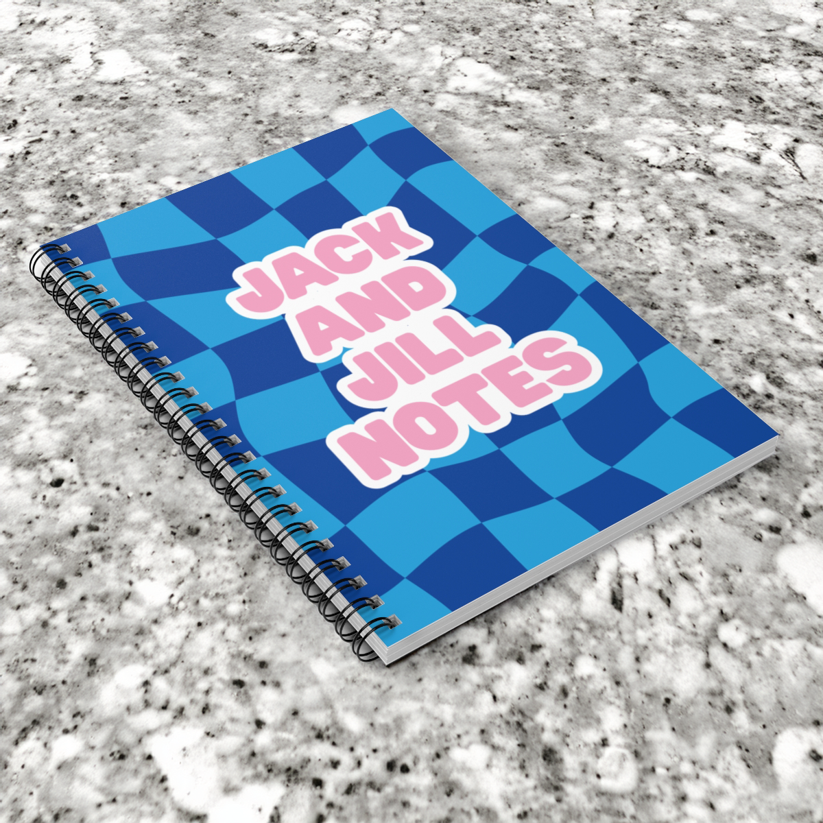 jack and jill Notebook with 'Jack and Jill Notes' text on a checkered blue and white pattern, placed on a gray surface.