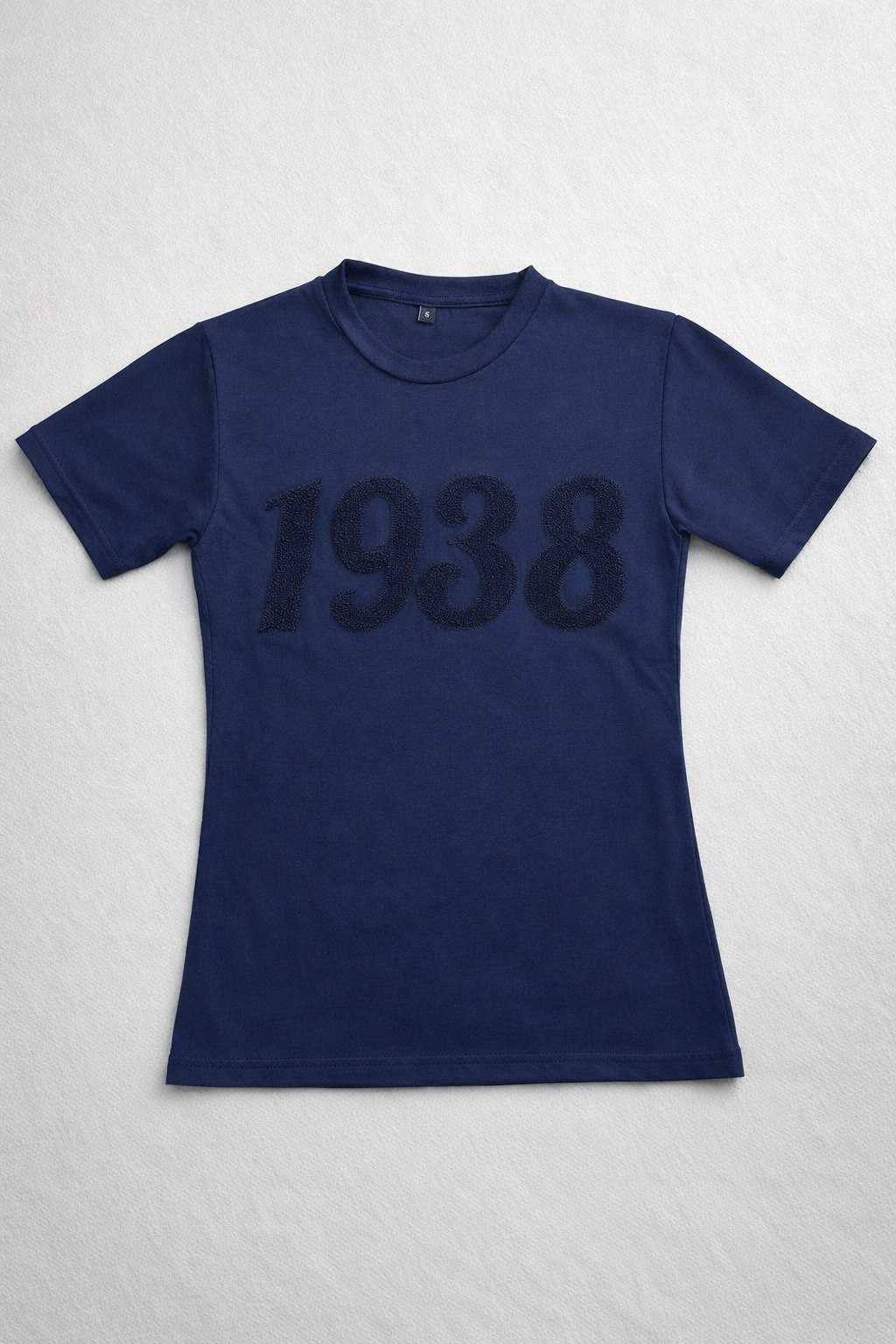 Navy blue t-shirt with chenille '1938' applique on a light gray background