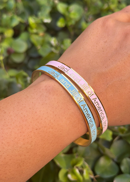 Jack and Jill of America gold cuff bracelets shown in pink and blue
