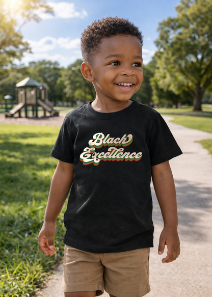 Child wearing a black t-shirt with 'Black Excellence' text in a park