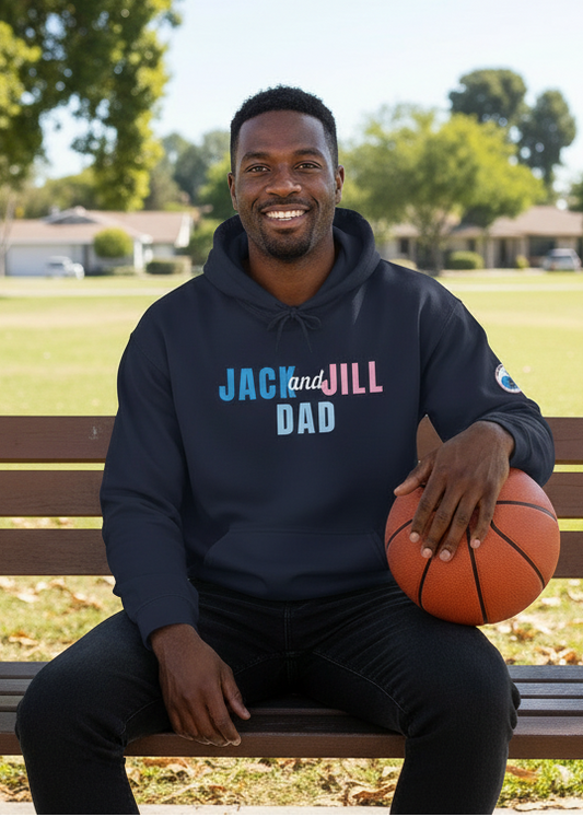Man sitting on a park bench holding a basketball, wearing a hoodie with 'Jack and Jill Dad' text.