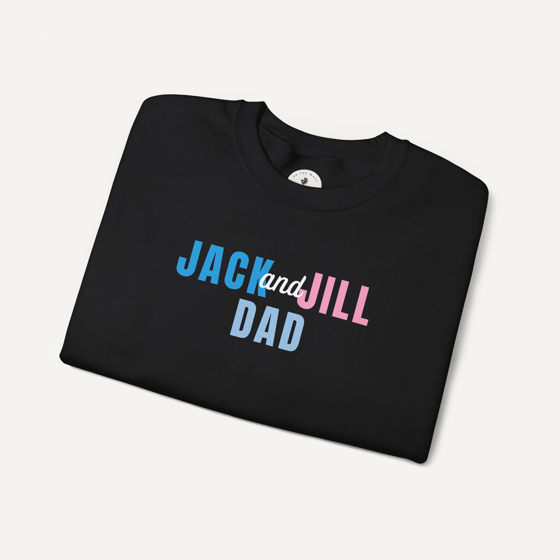 Folded black t-shirt with 'Jack and Jill Dad' text on a light gray background