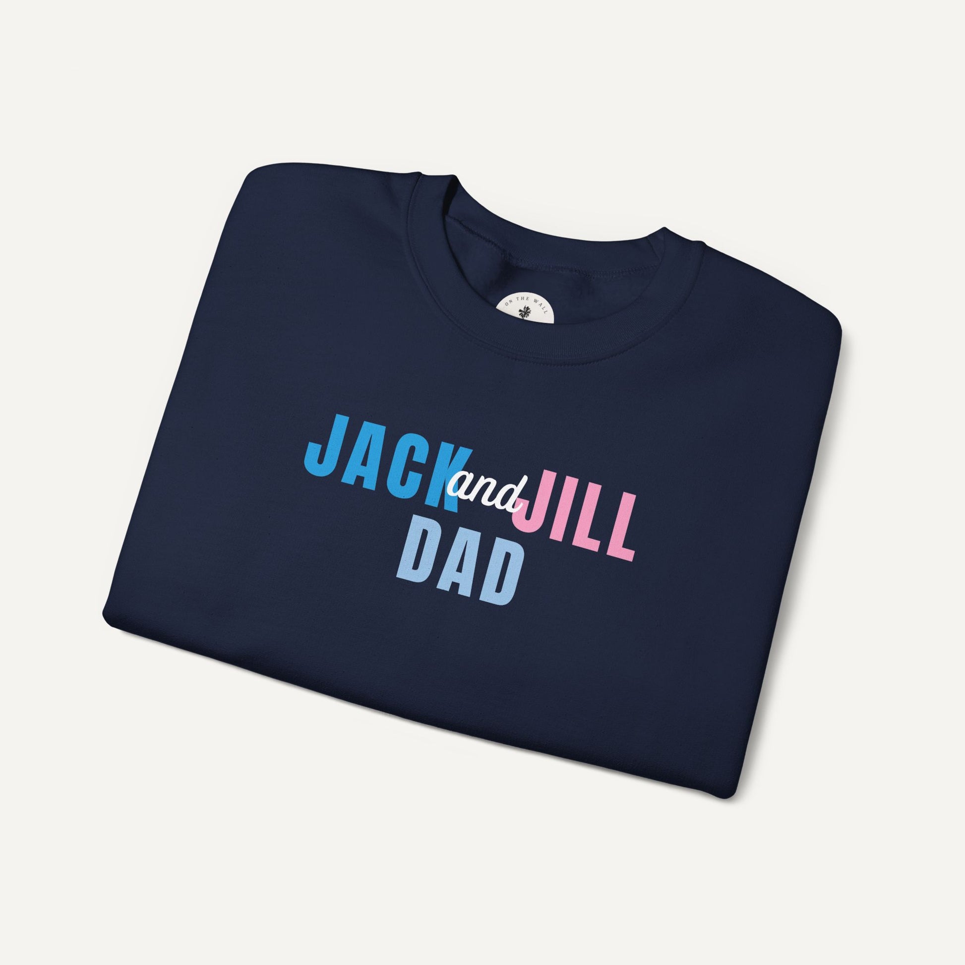 Folded navy blue t-shirt with 'Jack and Jill Dad' text on a light gray background