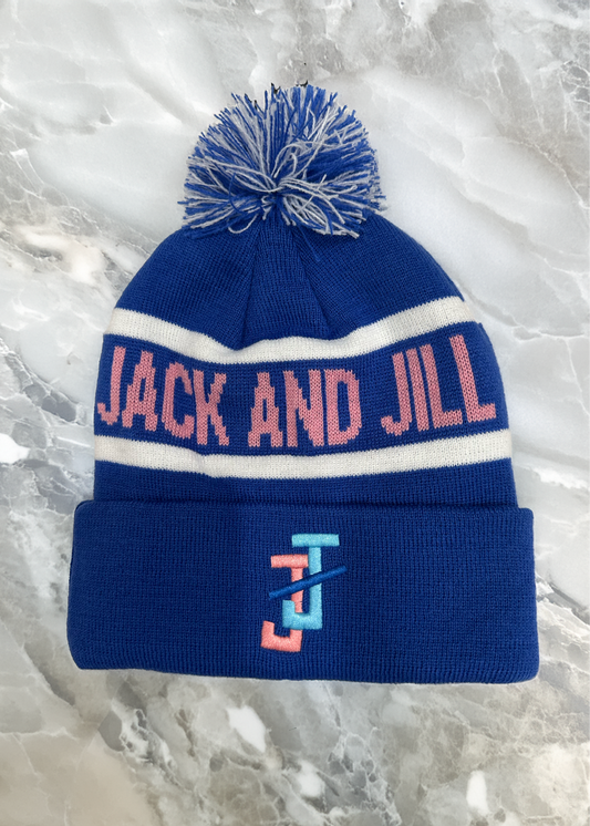Blue beanie with pom-pom and 'Jack and Jill' branding on a marble surface