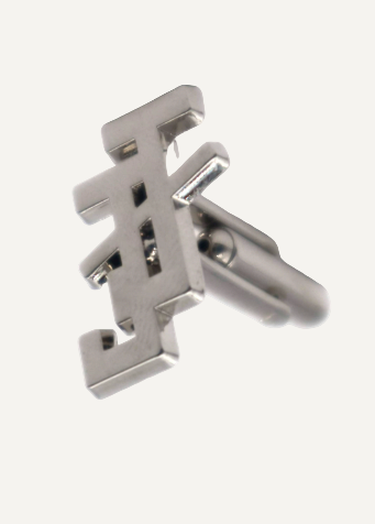 Metallic cufflinks with a design on a white background