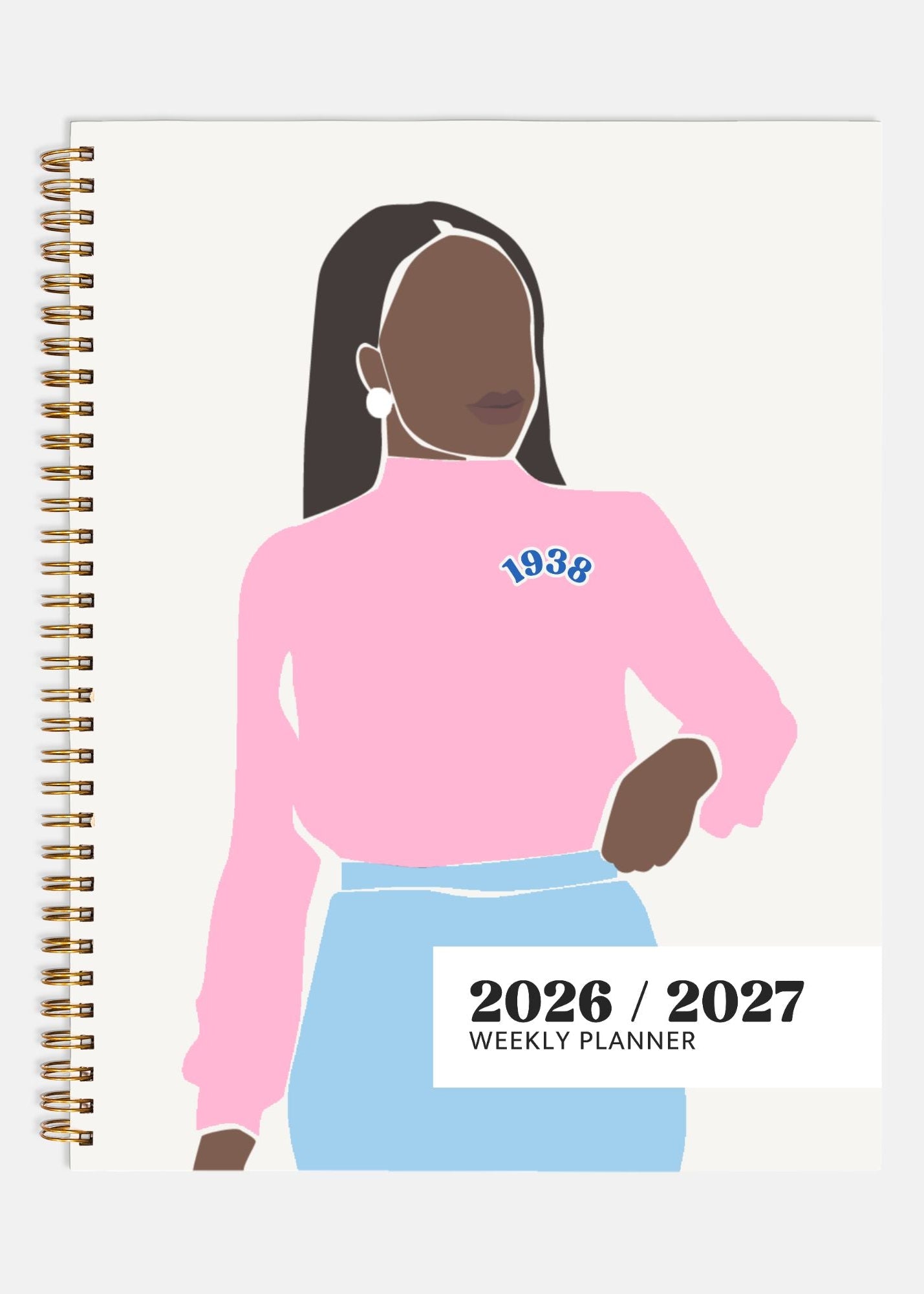 Planner with illustration of a person wearing a pink sweatshirt and blue skirt, with '1938' printed on the sweatshirt.