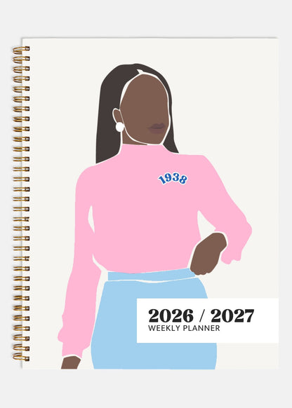 Planner with illustration of a person wearing a pink sweatshirt and blue skirt, with '1938' printed on the sweatshirt.