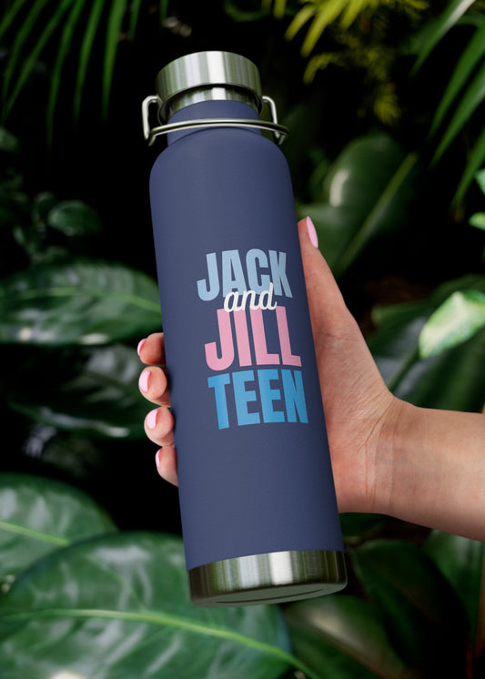 Hand holding a navy blue water bottle with 'Jack and Jill Teen' text against a leafy green background