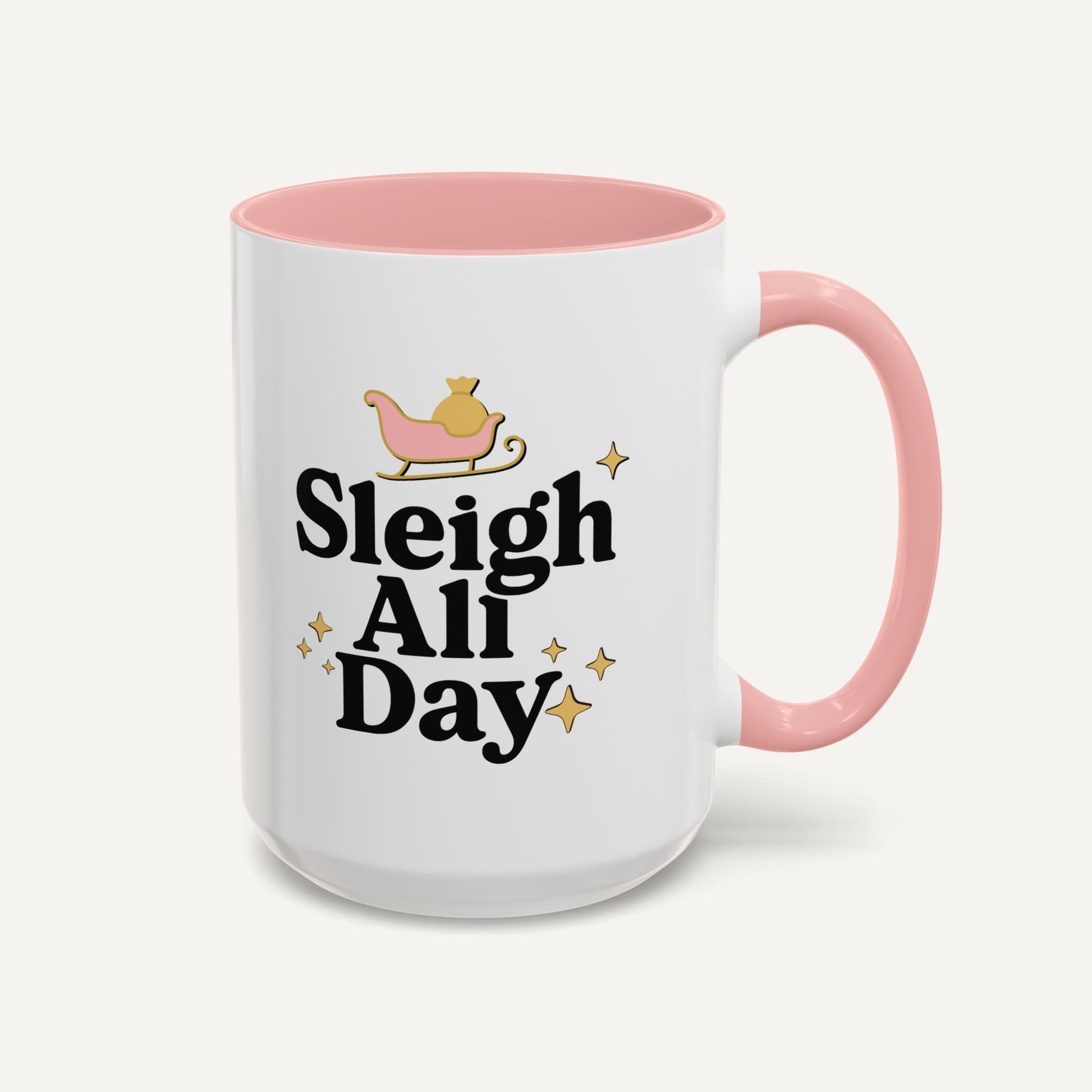 White mug with pink interior and handle featuring 'Sleigh All Day' text and sleigh illustration.