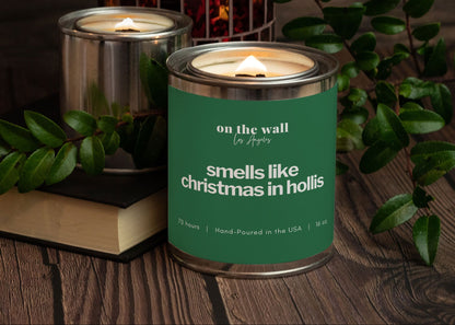 Candle in a tin canister with label "smells like christmas in hollis"